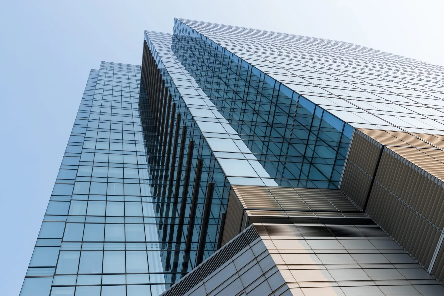Glasfassade eines Bürogebäudes in Untersicht gegen den Himmel, große Isolierglasfelder in Aluminiumkonstruktion